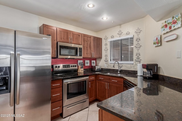 5751 N Kolb Rd Unit 25203, Tucson, AZ 85750 - kitchen featuring appliances with stainless steel finishes, a sink, dark stone counters, brown cabinets, and light tile patterned floors