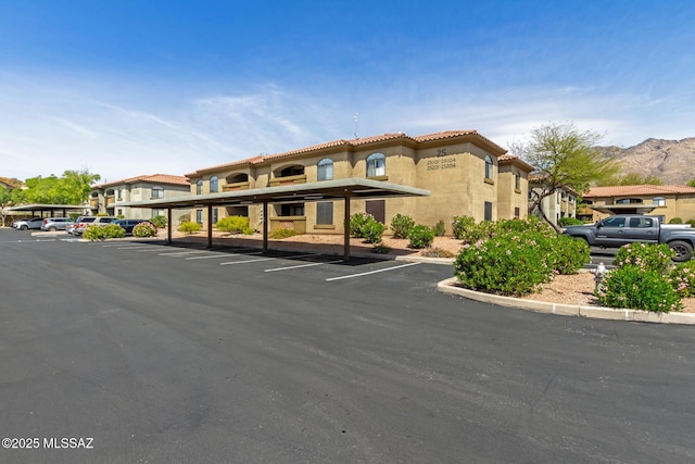5751 N Kolb Rd Unit 25203, Tucson, AZ 85750 - view of property featuring covered and uncovered parking and a mountain view