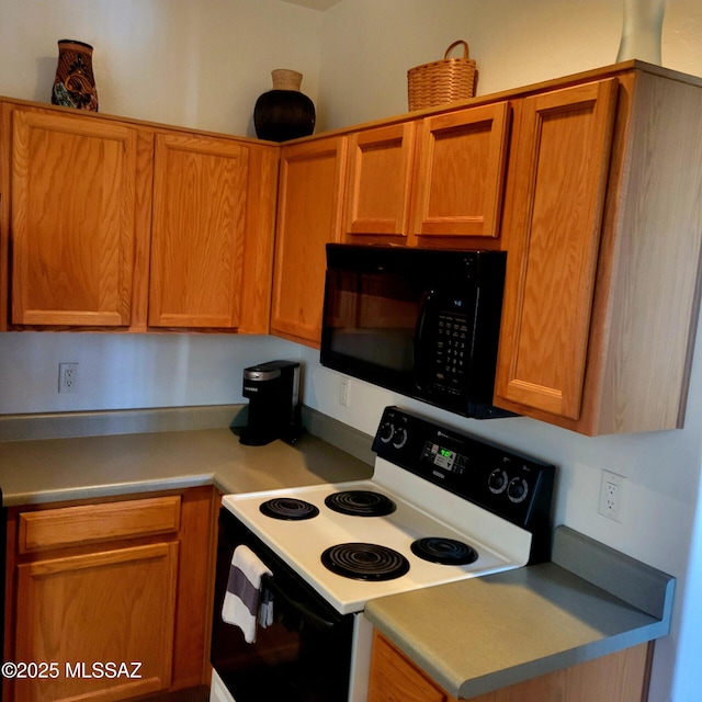 536 W Deerview Ct, Green Valley, AZ 85614 - kitchen with black microwave, electric range oven, brown cabinets, and light countertops