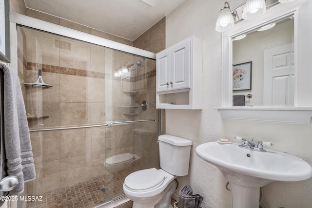 625 S Prudence Rd Apt 201, Tucson, AZ 85710 - bathroom featuring toilet, a shower stall, a sink, and a textured wall