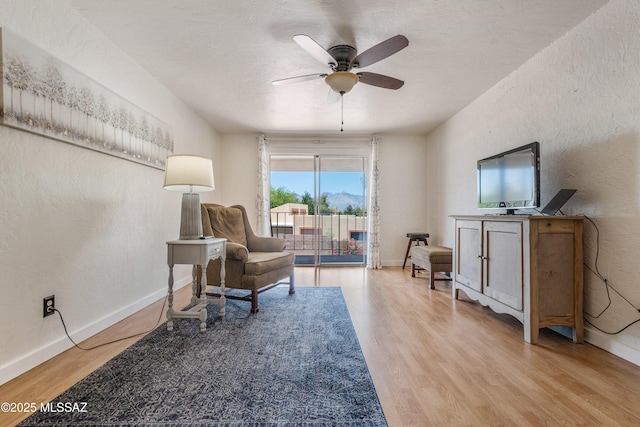 625 S Prudence Rd Apt 201, Tucson, AZ 85710 - living area with wood finished floors, a ceiling fan, baseboards, and a textured wall