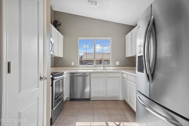 8079 N Eve Ann Way, Tucson, AZ 85741 - kitchen featuring appliances with stainless steel finishes, a sink, white cabinetry, light countertops, and lofted ceiling