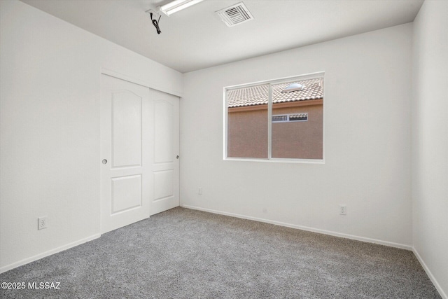 8079 N Eve Ann Way, Tucson, AZ 85741 - unfurnished bedroom featuring carpet flooring, baseboards, and a closet