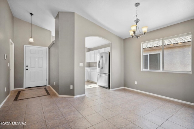 8079 N Eve Ann Way, Tucson, AZ 85741 - foyer entrance featuring high vaulted ceiling, a chandelier, light tile patterned floors, and baseboards