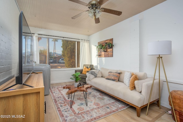 4308 E Elmwood St, Tucson, AZ 85711 - living room with wood finished floors, ceiling fan, and baseboards