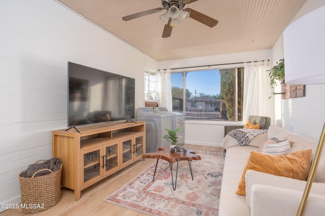 4308 E Elmwood St, Tucson, AZ 85711 - living area featuring washer and dryer, light wood finished floors, and a ceiling fan