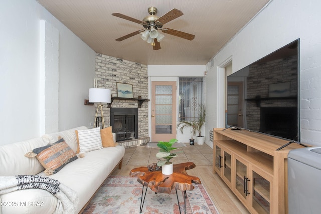 4308 E Elmwood St, Tucson, AZ 85711 - living area featuring a fireplace, ceiling fan, and wood finished floors