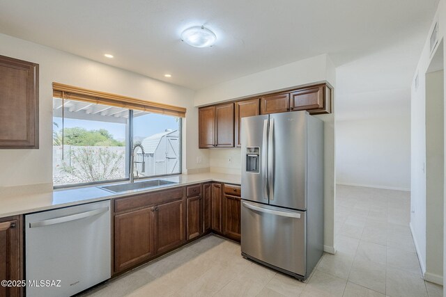 9415 E Simon Pl, Tucson, AZ 85710 - kitchen with stainless steel appliances, light countertops, recessed lighting, and light tile patterned floors
