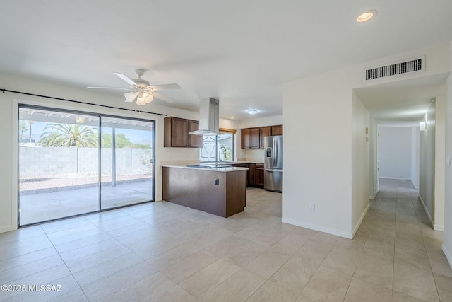 9415 E Simon Pl, Tucson, AZ 85710 - kitchen with island exhaust hood, stainless steel fridge with ice dispenser, a peninsula, light countertops, and a ceiling fan