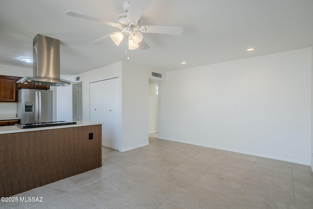 9415 E Simon Pl, Tucson, AZ 85710 - kitchen featuring island range hood, stainless steel refrigerator with ice dispenser, black stovetop, ceiling fan, and light countertops