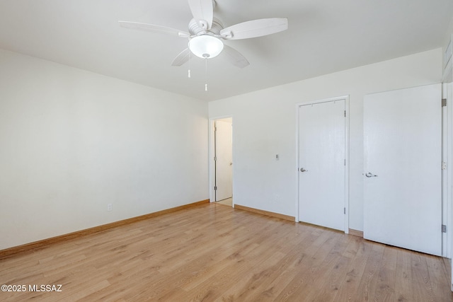 9415 E Simon Pl, Tucson, AZ 85710 - unfurnished bedroom featuring light wood finished floors and a ceiling fan