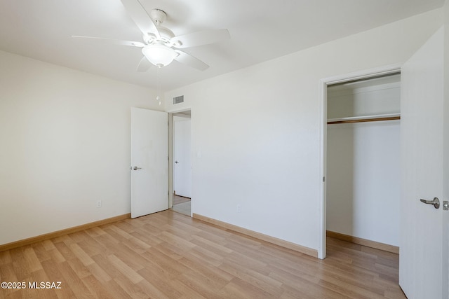 9415 E Simon Pl, Tucson, AZ 85710 - unfurnished bedroom with light wood-style flooring, a closet, and a ceiling fan