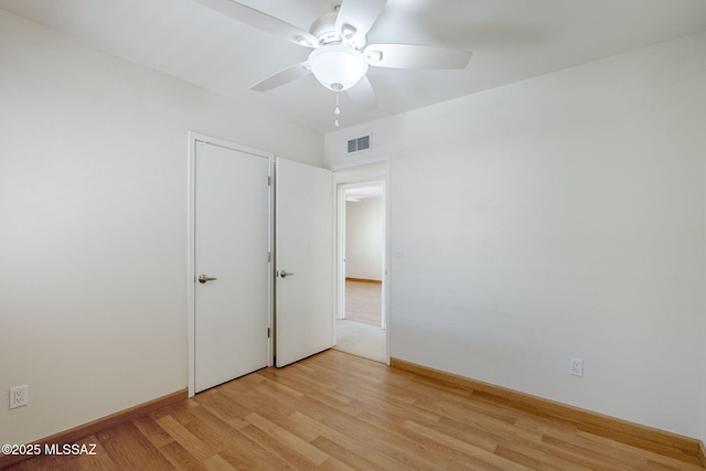 9415 E Simon Pl, Tucson, AZ 85710 - unfurnished bedroom featuring light wood-style flooring and a ceiling fan
