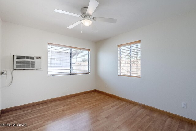 9415 E Simon Pl, Tucson, AZ 85710 - spare room featuring light wood-type flooring, a wall mounted AC, and a ceiling fan