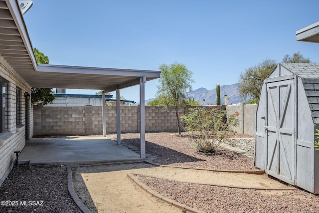 9415 E Simon Pl, Tucson, AZ 85710 - fenced backyard with a patio, a mountain view, and a storage unit