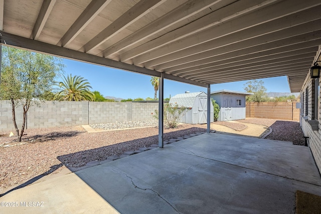 9415 E Simon Pl, Tucson, AZ 85710 - fenced backyard featuring a storage shed and a patio area