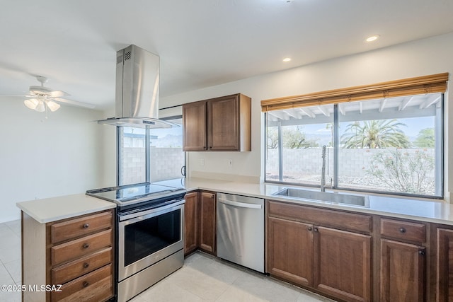 9415 E Simon Pl, Tucson, AZ 85710 - kitchen featuring appliances with stainless steel finishes, island exhaust hood, a peninsula, plenty of natural light, and recessed lighting