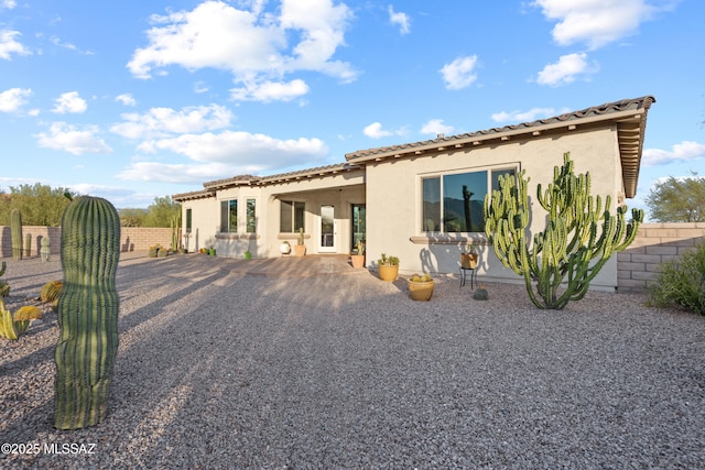 12475 N Faraway Wash Trl, Marana, AZ 85658 - rear view of house featuring stucco siding, a tiled roof, and a patio