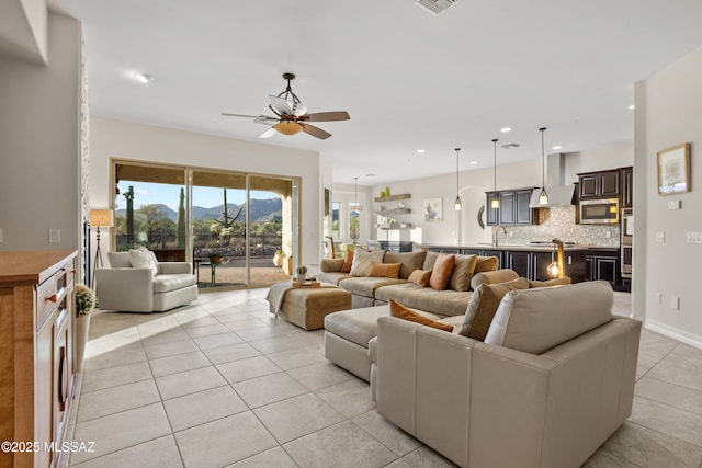 12475 N Faraway Wash Trl, Marana, AZ 85658 - living room featuring light tile patterned flooring, a ceiling fan, recessed lighting, and a mountain view
