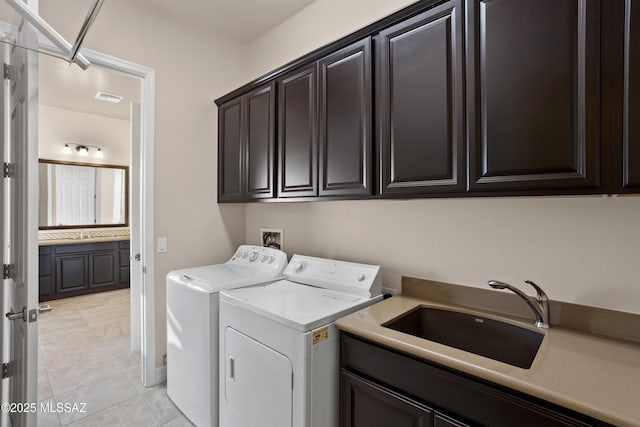 12475 N Faraway Wash Trl, Marana, AZ 85658 - laundry area featuring washing machine and dryer, cabinet space, and light tile patterned floors
