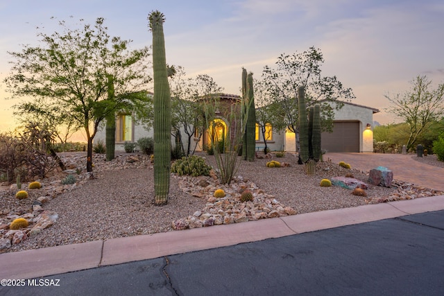 12475 N Faraway Wash Trl, Marana, AZ 85658 - view of front of home featuring driveway, stucco siding, and an attached garage