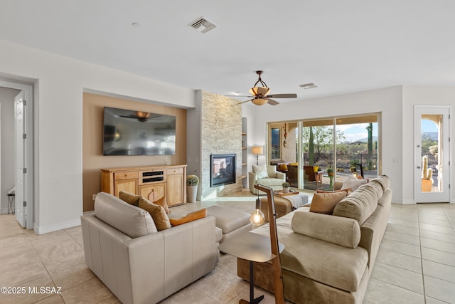 12475 N Faraway Wash Trl, Marana, AZ 85658 - living room with ceiling fan, light tile patterned flooring, and a fireplace