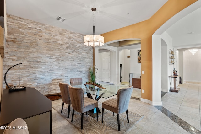 12475 N Faraway Wash Trl, Marana, AZ 85658 - dining area with arched walkways and light tile patterned flooring