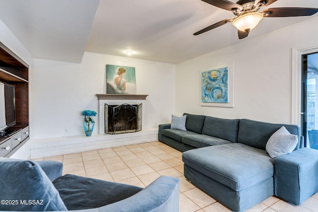 4990 N Kolb Rd, Tucson, AZ 85750 - living room with light tile patterned flooring, a ceiling fan, and a fireplace