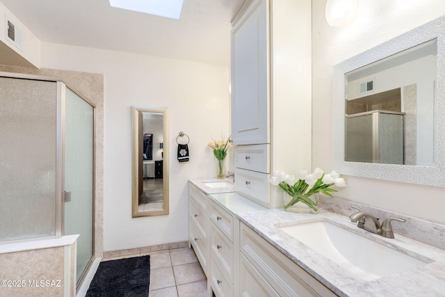 4990 N Kolb Rd, Tucson, AZ 85750 - bathroom with a shower stall, double vanity, a skylight, and tile patterned floors
