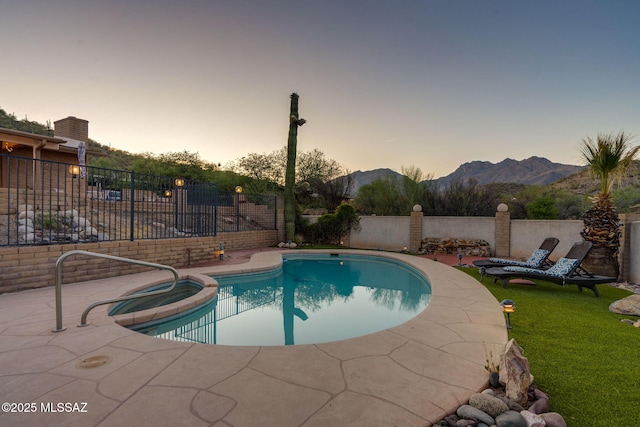 4990 N Kolb Rd, Tucson, AZ 85750 - pool at dusk featuring a fenced backyard, a pool with connected hot tub, and a mountain view