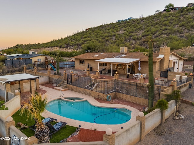4990 N Kolb Rd, Tucson, AZ 85750 - view of swimming pool featuring a patio area, a playground, a fenced backyard, and a pool with connected hot tub