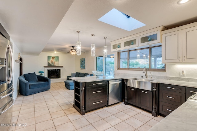 4990 N Kolb Rd, Tucson, AZ 85750 - kitchen with appliances with stainless steel finishes, light tile patterned floors, white cabinets, and light stone counters