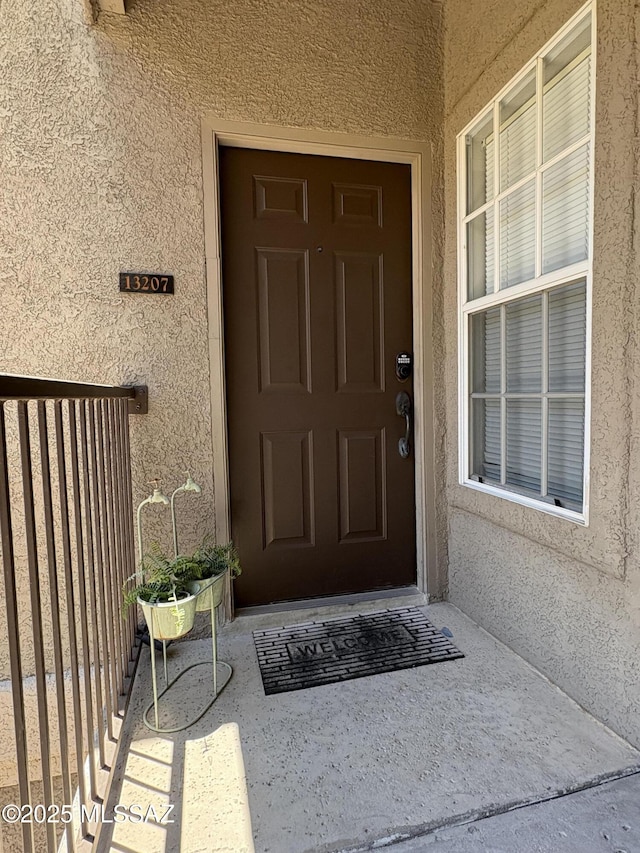 1500 E Pusch Wilderness Dr Unit 13207, Oro Valley, AZ 85737 - doorway to property with stucco siding