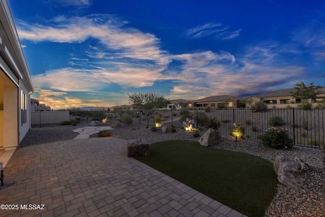30755 S Chestnut Way, Oracle, AZ 85623 - yard at dusk with a patio, a fenced backyard, and a residential view