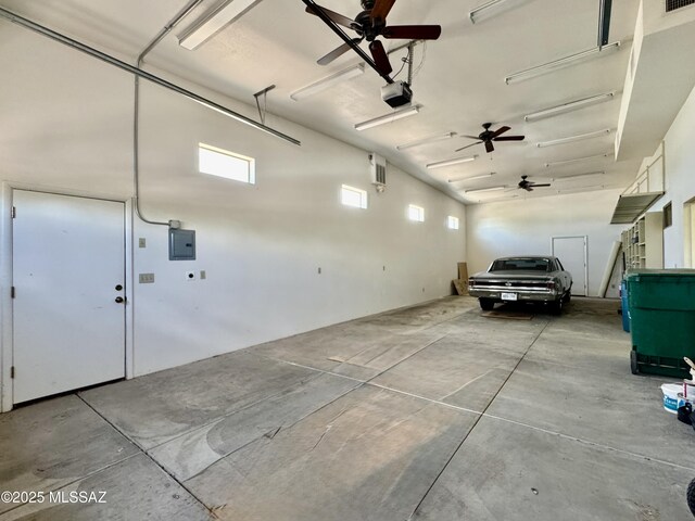 7621 N Placita De Los Amigos, Tucson, AZ 85704 - garage with a garage door opener, a ceiling fan, and electric panel