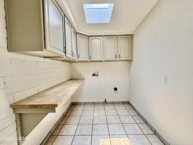 7621 N Placita De Los Amigos, Tucson, AZ 85704 - laundry room with a skylight, cabinet space, hookup for a washing machine, light tile patterned flooring, and hookup for an electric dryer