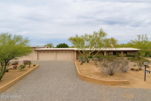 7621 N Placita De Los Amigos, Tucson, AZ 85704 - view of front facade with driveway, a garage, and stucco siding