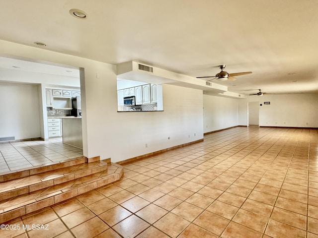 7621 N Placita De Los Amigos, Tucson, AZ 85704 - unfurnished living room featuring light tile patterned floors and ceiling fan