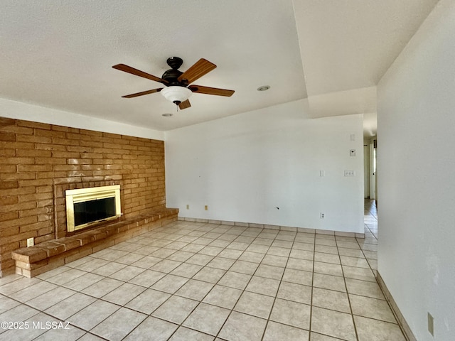 7621 N Placita De Los Amigos, Tucson, AZ 85704 - unfurnished living room with ceiling fan, light tile patterned floors, and a fireplace
