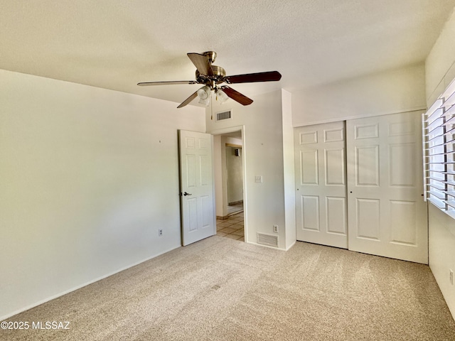 7621 N Placita De Los Amigos, Tucson, AZ 85704 - unfurnished bedroom featuring carpet, a closet, a textured ceiling, and ceiling fan