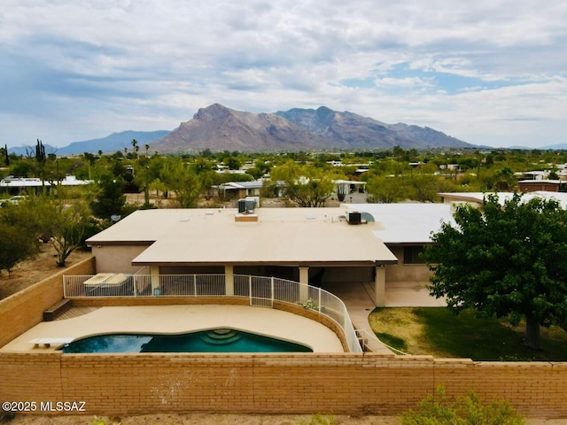 7621 N Placita De Los Amigos, Tucson, AZ 85704 - rear view of property with a mountain view, an outdoor pool, and stucco siding