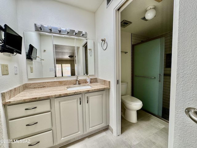 7621 N Placita De Los Amigos, Tucson, AZ 85704 - bathroom featuring vanity, a shower stall, a textured wall, and tile patterned flooring