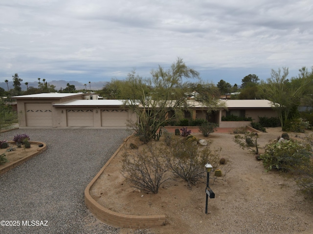 7621 N Placita De Los Amigos, Tucson, AZ 85704 - ranch-style home featuring a mountain view and gravel driveway