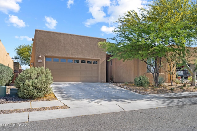 8984 E Wright School Loop, Tucson, AZ 85715 - adobe home featuring stucco siding, concrete driveway, and an attached garage