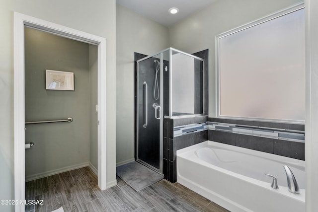 8984 E Wright School Loop, Tucson, AZ 85715 - bathroom featuring a shower stall, a bath, and wood finished floors