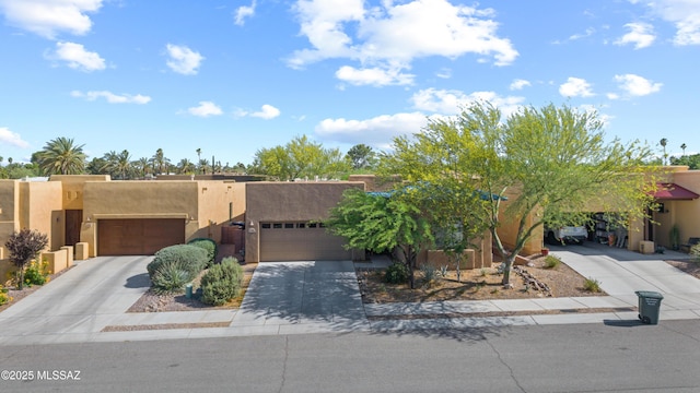 8984 E Wright School Loop, Tucson, AZ 85715 - adobe home featuring stucco siding, concrete driveway, and an attached garage