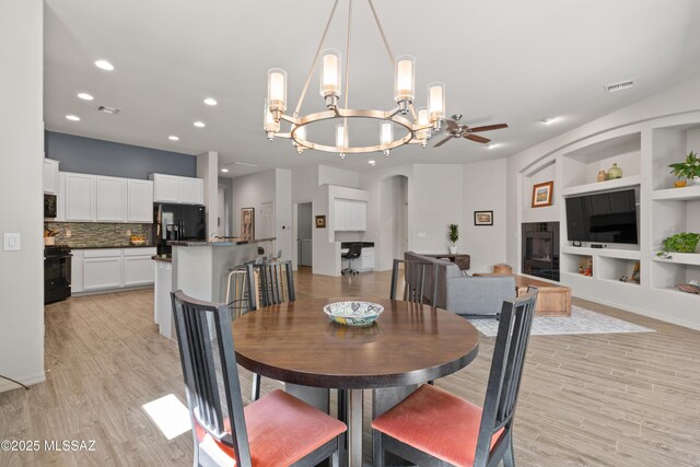 8984 E Wright School Loop, Tucson, AZ 85715 - dining space with light wood-style flooring, built in features, a chandelier, recessed lighting, and a ceiling fan
