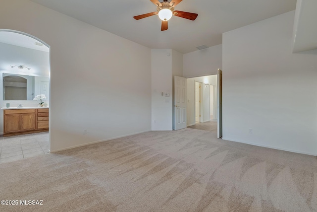 8191 N White Stallion Pl, Tucson, AZ 85743 - unfurnished room with light colored carpet, ceiling fan, and arched walkways