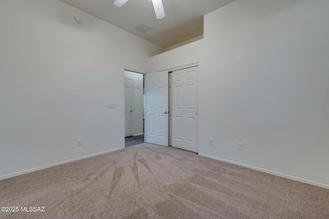 8191 N White Stallion Pl, Tucson, AZ 85743 - empty room featuring light carpet, vaulted ceiling, and ceiling fan