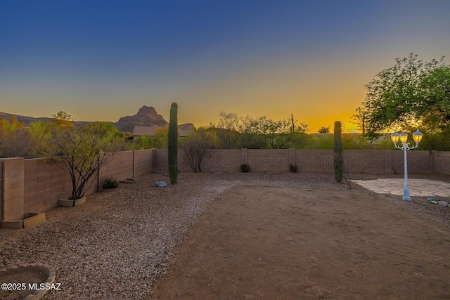 8191 N White Stallion Pl, Tucson, AZ 85743 - yard at dusk with a fenced backyard and a patio